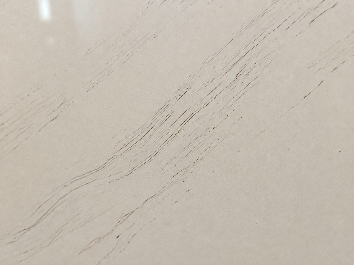 Close-up of polished Casablanca Quartz showing fragmented parallel strands and tiny crystalline sparkle