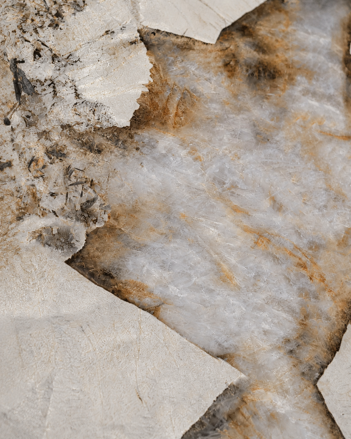 Close-up of Patagonia porcelain Face A with ivory minerals, icy gray crystalline depth and amber accents