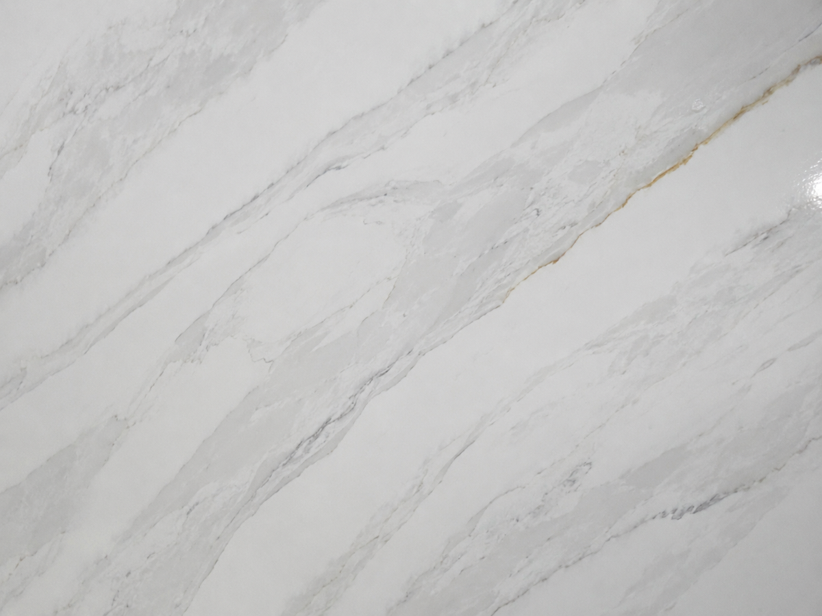 Detailed view of Golden Storm Quartz with open white lanes and soft silver-gray diagonal movement
