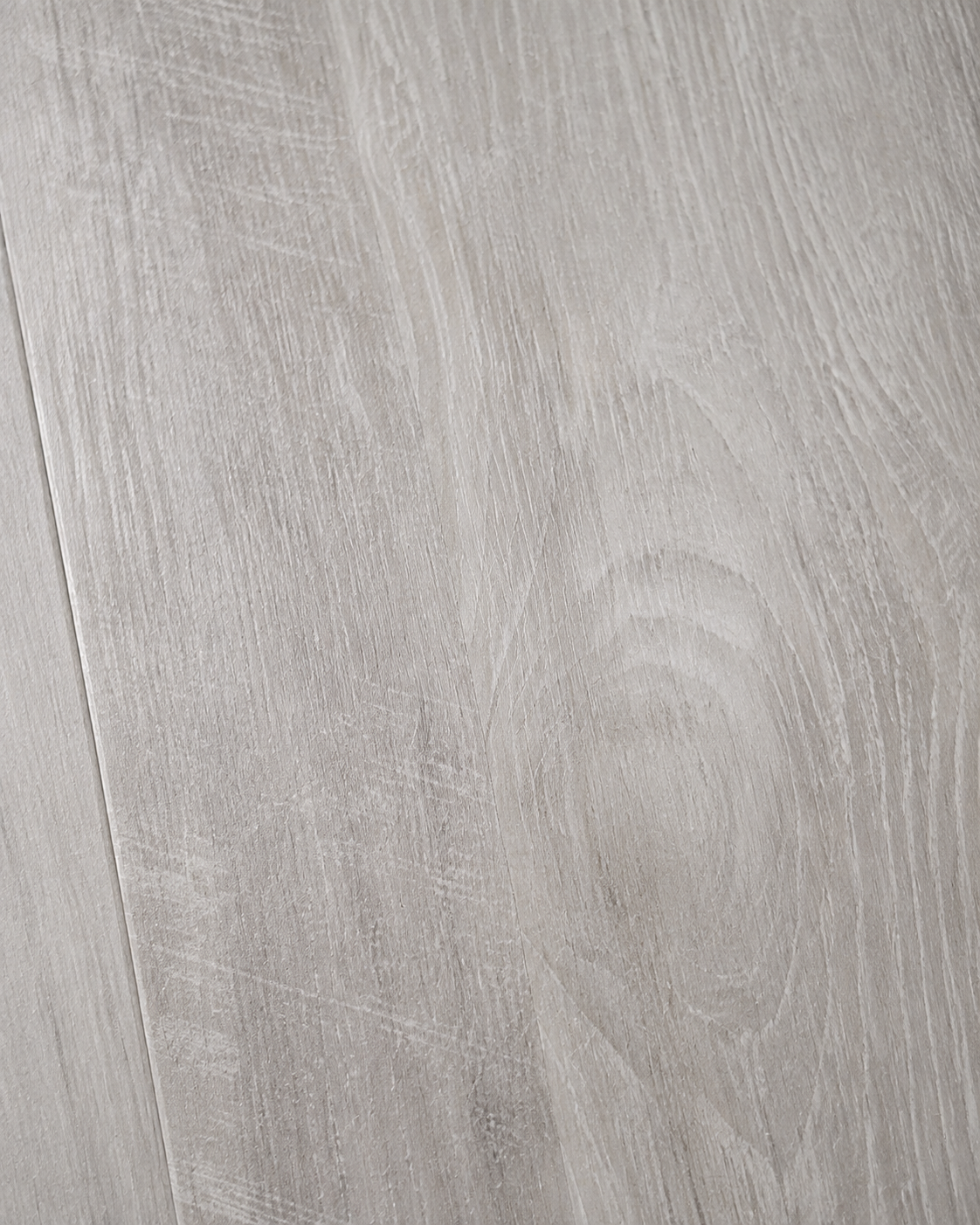 Close-up of Coastal Gray flooring showing whitewashed gray oak grain and subtle saw-mark detail