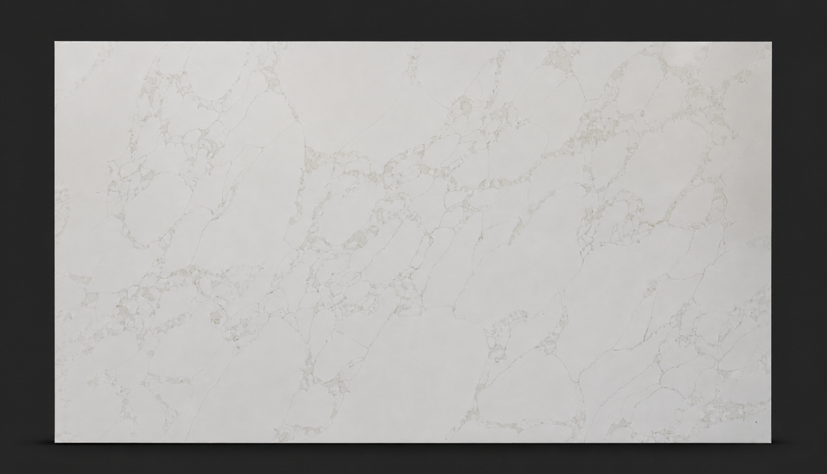 Full slab of Calacatta Eterna Quartz with soft beige veining across a warm white background