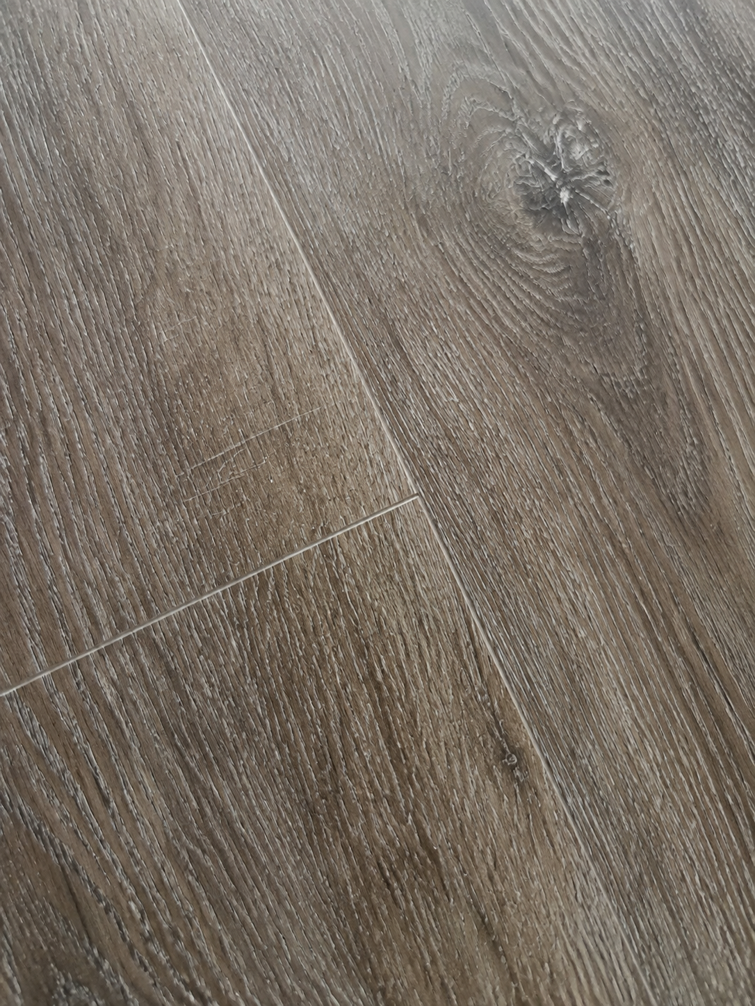 Rustic Walnut SPC flooring grain, knot detail, and micro-beveled joint